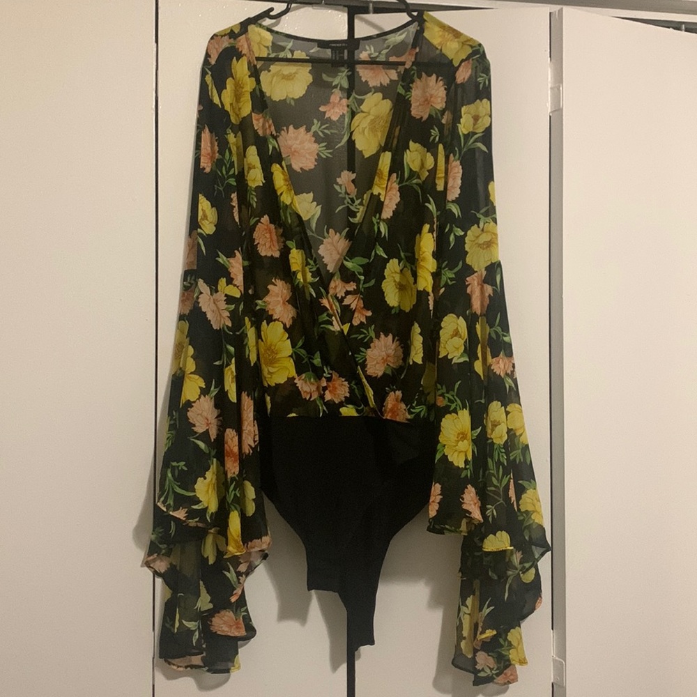 Sheer black with floral print wrap style body suit with voluminous sleeves.